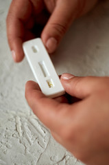 Self-testing of blood for viruses. The girl checks herself