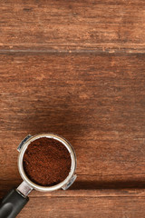 freshly ground coffee beans in a porta filter by the coffee grinder roasted make beans into a powder.