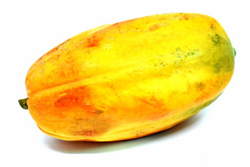 Large yellow ripe papaya is placed on a white background, isolated.