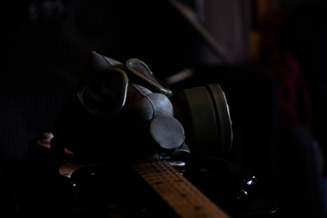 Military Gas Mask on a electric guitar in dark ambient. Coronavirus, Covid19 pandemic prevention....