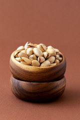 Pistachio nuts in a wooden plate.Healthy nutrition. Food Vegetarian.