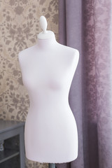 Female mannequin in the room. Sewing studio, tailoring and fashion design.
