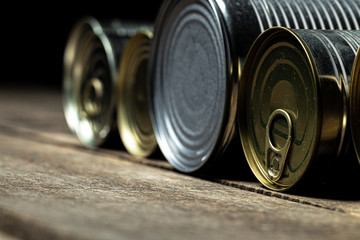 Tin cans with food on the table. Close up.