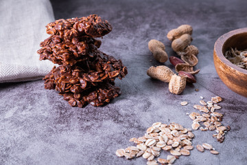 Oatmeal cookies pile on concrete background with peanuts. Healthy snack.