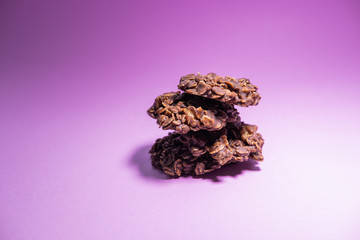 Oatmeal cookies pile with chocolate and peanut butter isolated on pink background. Healthy snack. Conceptual picture.