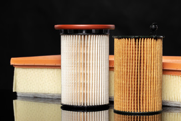 Car engine filter on dark background.