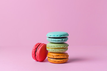 Beautiful colorful desserts. french macaroons on a pink background