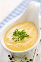 Hollandaise sauce. Classic French cuisine sauce. Emulsion sauce of butter and egg yolks with vinegar.