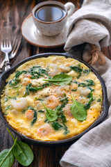 Scrambled eggs with prawns, cheese and spinach.