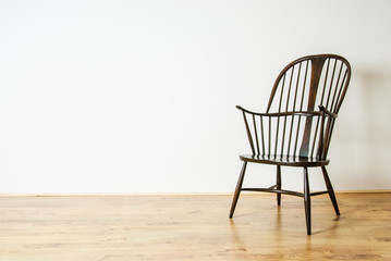 Single Windsor style chair in empty room