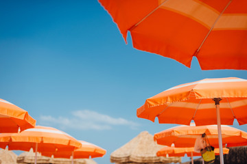 Summer blue sky, view through umbrellas. Summer vacation at the beach