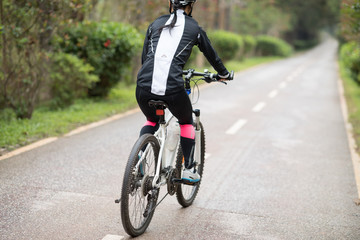 Fototapeta na wymiar Cyclist use smartphone when riding mountain bike on forest trail