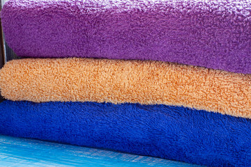 Stack of clean towels on bed