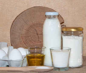ingredients for dough and baking prepearing pancakes ,flitters,dumplings, vareniks from eggs,flour,milk,salt,sugar and eggs