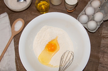 ingredients for dough and baking prepearing pancakes ,flitters,dumplings, vareniks from eggs,flour,milk,salt,sugar and eggs