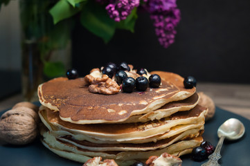 .morning breakfast pancakes .fritters with honey nuts and currants lilac copy space