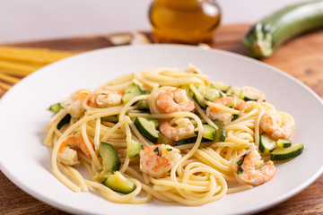 Spaghetti with shrimps and zucchini. Typical dish on italian cuisine. Summer lunch.