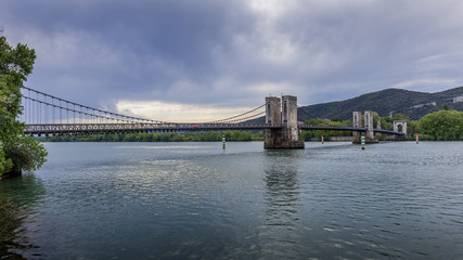 View of the Pont du Robinet bridge with a cloudy sky highlighting its metallic structure, Donzère, France