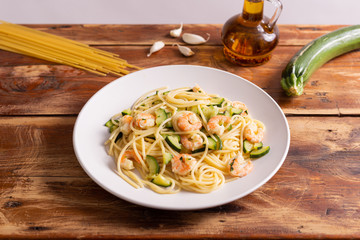 Spaghetti with shrimps and zucchini. Typical dish on italian cuisine. Summer lunch.