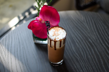 rose and iced mocha coffee on the table.