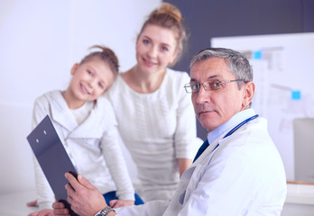 Fototapeta premium Little girl with her mother at a doctor on consultation