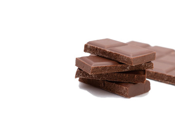 Pieces of chocolate on a white background, isolate. Broken chocolate bar