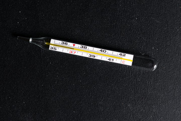 thermometer on a dark background