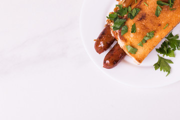 Double hot dogs with french brioche buns and caramelized onions with mayo sauce and ketchup.