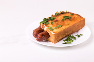 Double hot dogs with french brioche buns and caramelized onions with mayo sauce and ketchup.