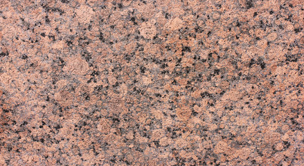 Granite rock texture background close up view. Grey black and pale pink mineral marbel stone...