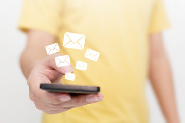 Close-up image hand using smartphone with icon envelope email. Contact us customer service or e-mail marketing concept