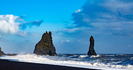 The cliffs by the township of Vik in Iceland Reynisdrangar basalt sea stacks