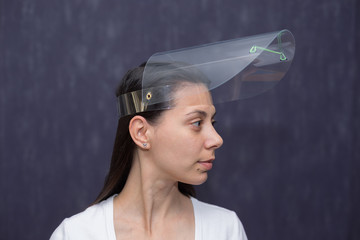 Portrait of a girl in a plastic protective mask on her head. Different angles