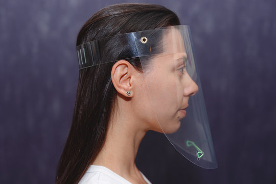 Portrait of a girl in a plastic protective mask on her head. Different angles