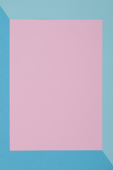 Blue and pink background, colored paper geometrically divides into zones, frame, copy, space.