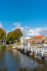 Fototapeta na wymiar The white bridge in Toenning with the store house in background