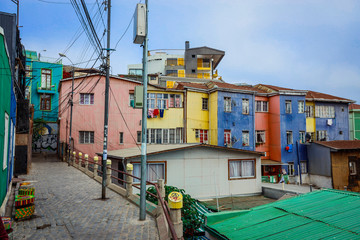 Fototapeta na wymiar Panoramic View to the Mountain Hills with the Colorful and Bright Buildings with Painting, Valparaiso, Chile 