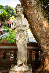Water Palace of Tirta Gangga in East Bali, Indonesia. Stone figures of balinese gods