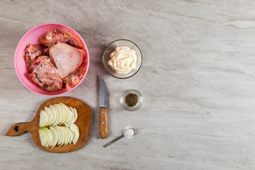 Chicken thighs with onions and mayonnaise, a simple recipe for homemade attraction, preparation for baking.