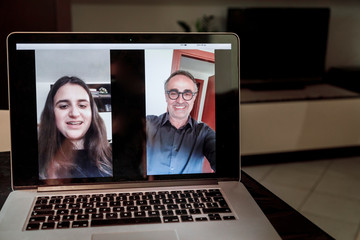 Video chiamata da notebook tra una ragazzina e il padre