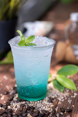 a cup of sweet soda ice on wooden floor