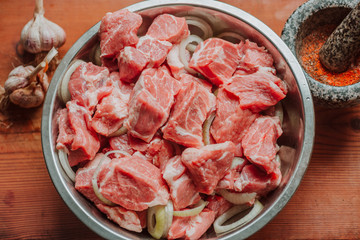 Raw pork belly pieces on a wooden cutting board