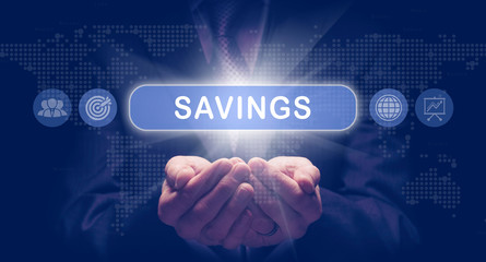 Businessmans cupped hands holding an Savings business concept on a computerised display.