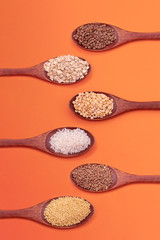 Different types of cereals on a wooden spoon. Grains for the preparation of soups and side dishes, ingredients