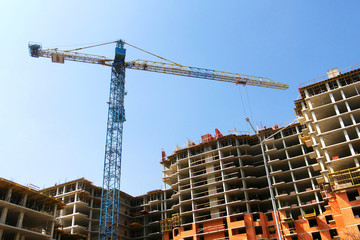Construction site with crane and building. Crane and building under construction.
