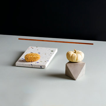 Pumpkin, stone and tile on table