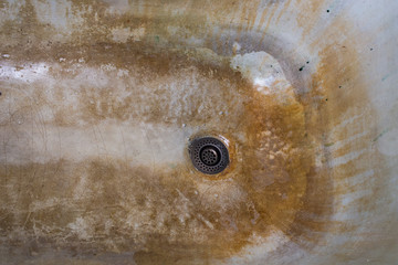 old rusted and stained cast iron bathtub close-up