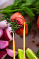 sausages on fire. Vegetables fried sausages