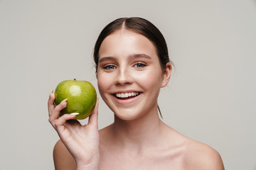 Image of beautiful laughing shirtless woman posing with green apple