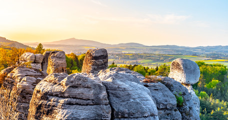 Sandstone rock town near Hruba Skala. Jested Mountain on background. Spring landscape of Bohemian...